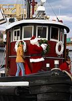 Santa Claus arrives at Mystic River Park by tugboat